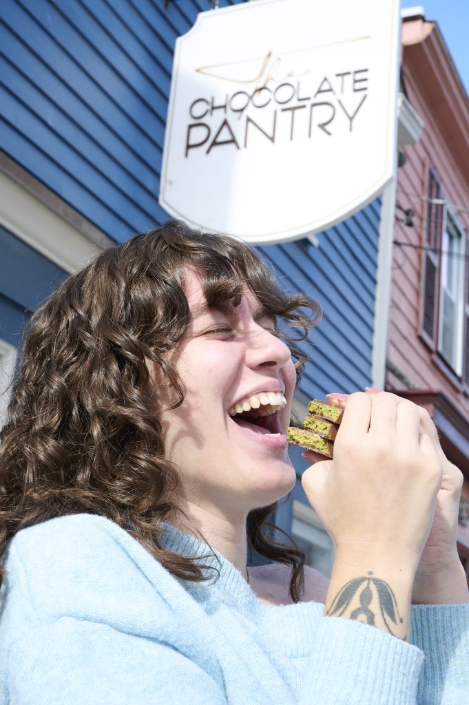 Happy human enjoying a dubai chocolate bar at The Chocolate Pantry